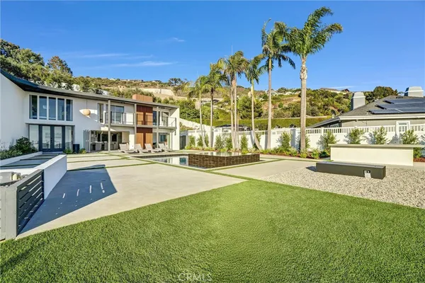 a view of a house with backyard and sitting area