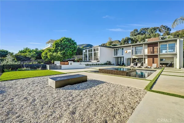 a backyard of a house with table and chairs