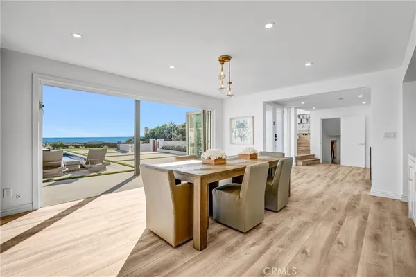 a large kitchen with kitchen island white cabinets and wooden floors