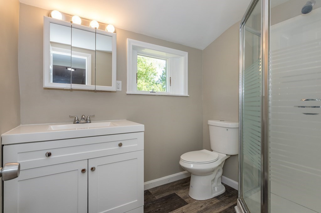 45 Shore Road Ashland, MA 01721 - Photo 13 of 21 a bathroom with a toilet a sink and mirror