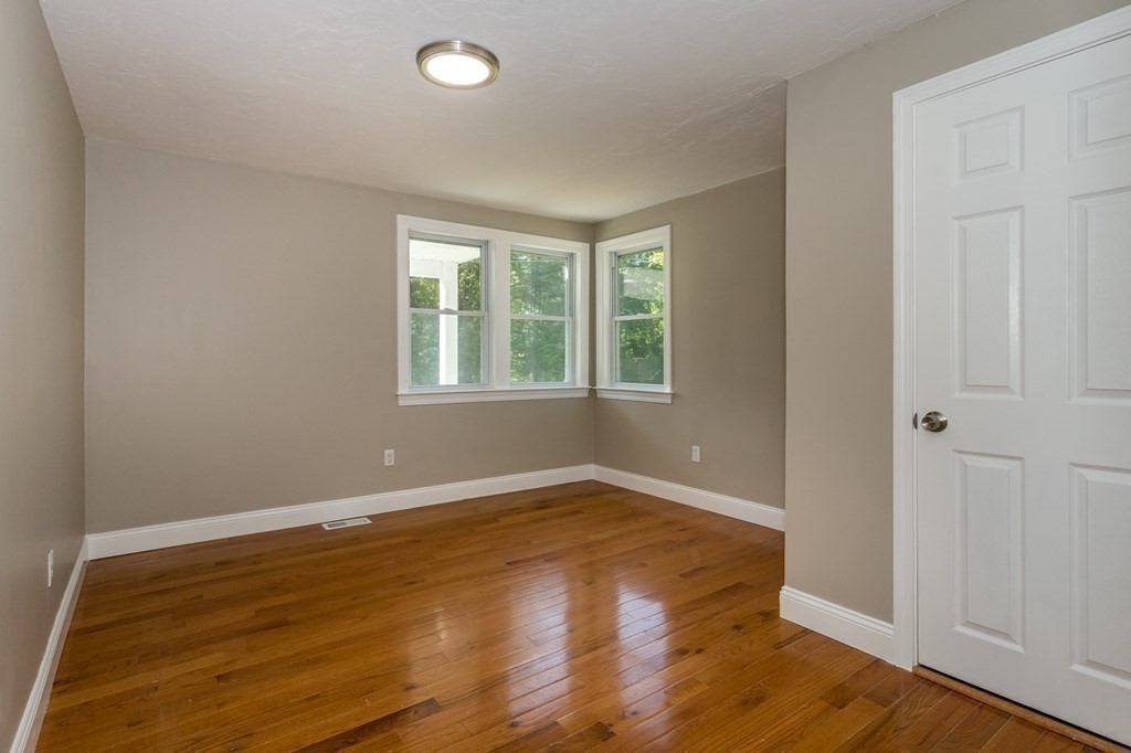 45 Shore Road Ashland, MA 01721 - Photo 16 of 21 an empty room with wooden floor and windows