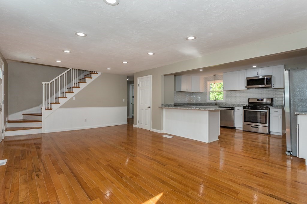 45 Shore Road Ashland, MA 01721 - Photo 5 of 21 a view of kitchen with kitchen island microwave and stove top oven