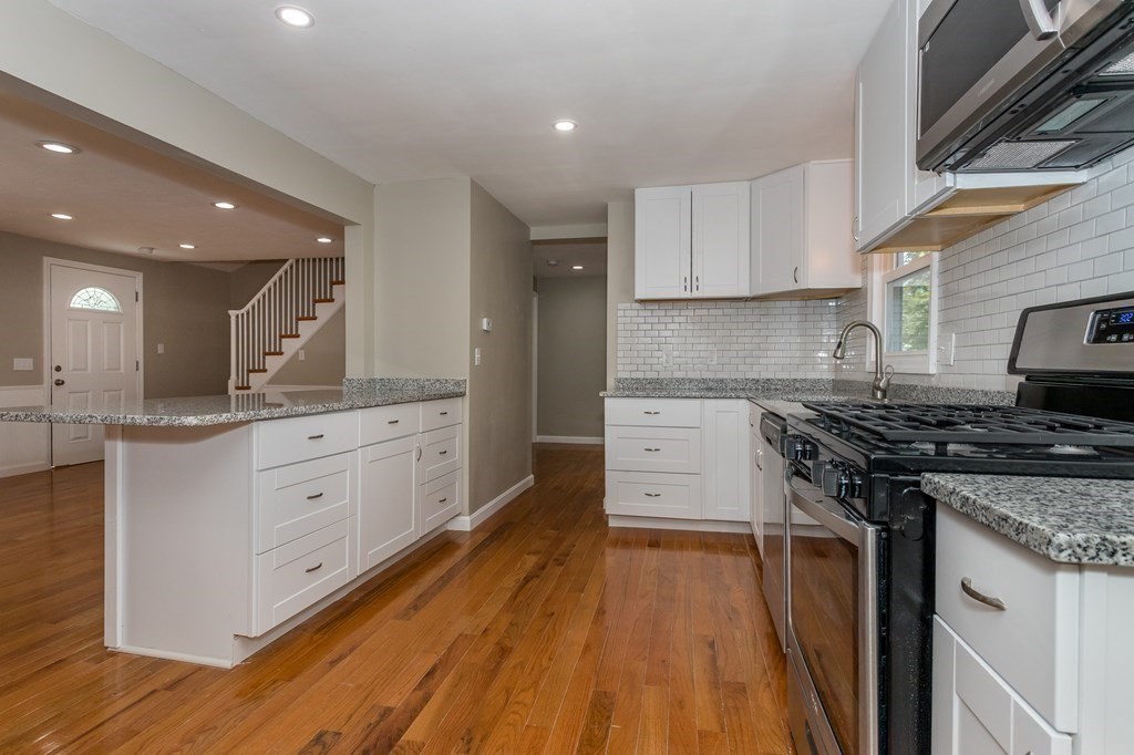 45 Shore Road Ashland, MA 01721 - Photo 7 of 21 a kitchen with stainless steel appliances granite countertop a stove and a sink