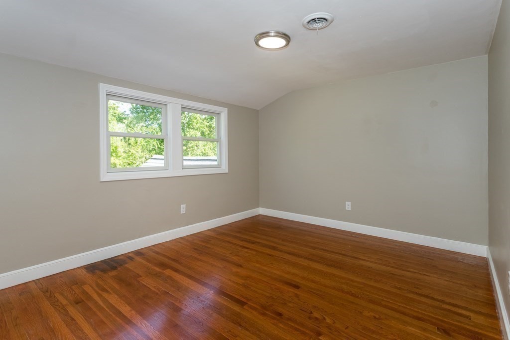 45 Shore Road Ashland, MA 01721 - Photo 9 of 21 an empty room with wooden floor and windows
