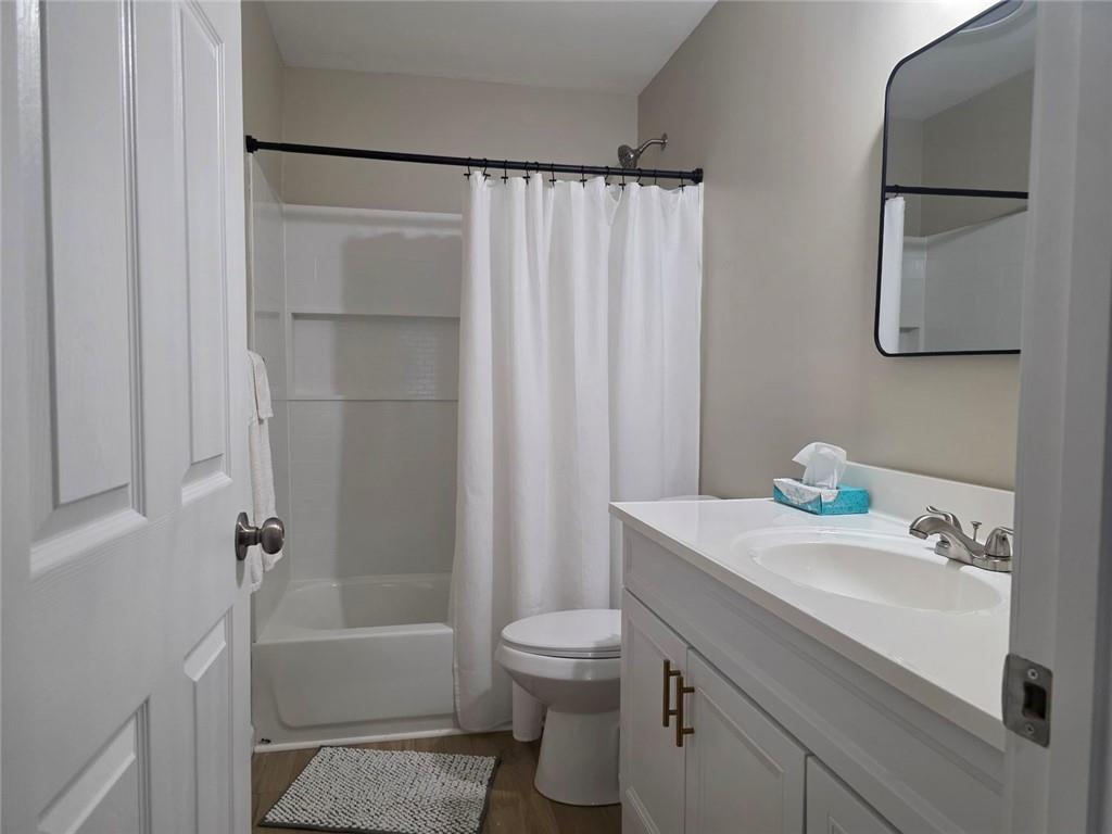 722 Lacy Street Monroe, GA 30655 - Photo 15 of 19 a bathroom with a sink toilet and shower