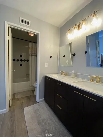 a bathroom with a sink a toilet and mirror
