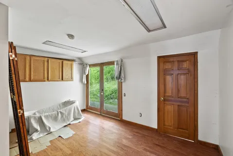 a kitchen with stainless steel appliances granite countertop a refrigerator a stove and a wooden floors