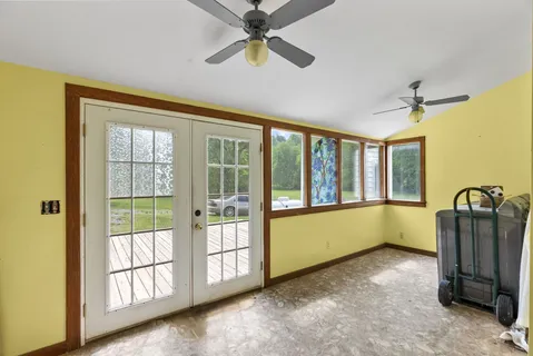 a view of a livingroom with wooden floor and stairs
