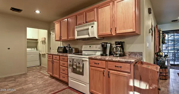 a kitchen with stainless steel appliances granite countertop a sink stove and cabinets