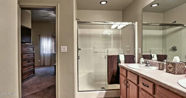 a bathroom with a shower sink and mirror