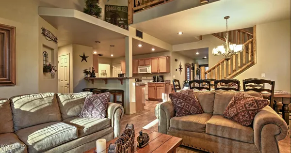 a living room with furniture and a chandelier