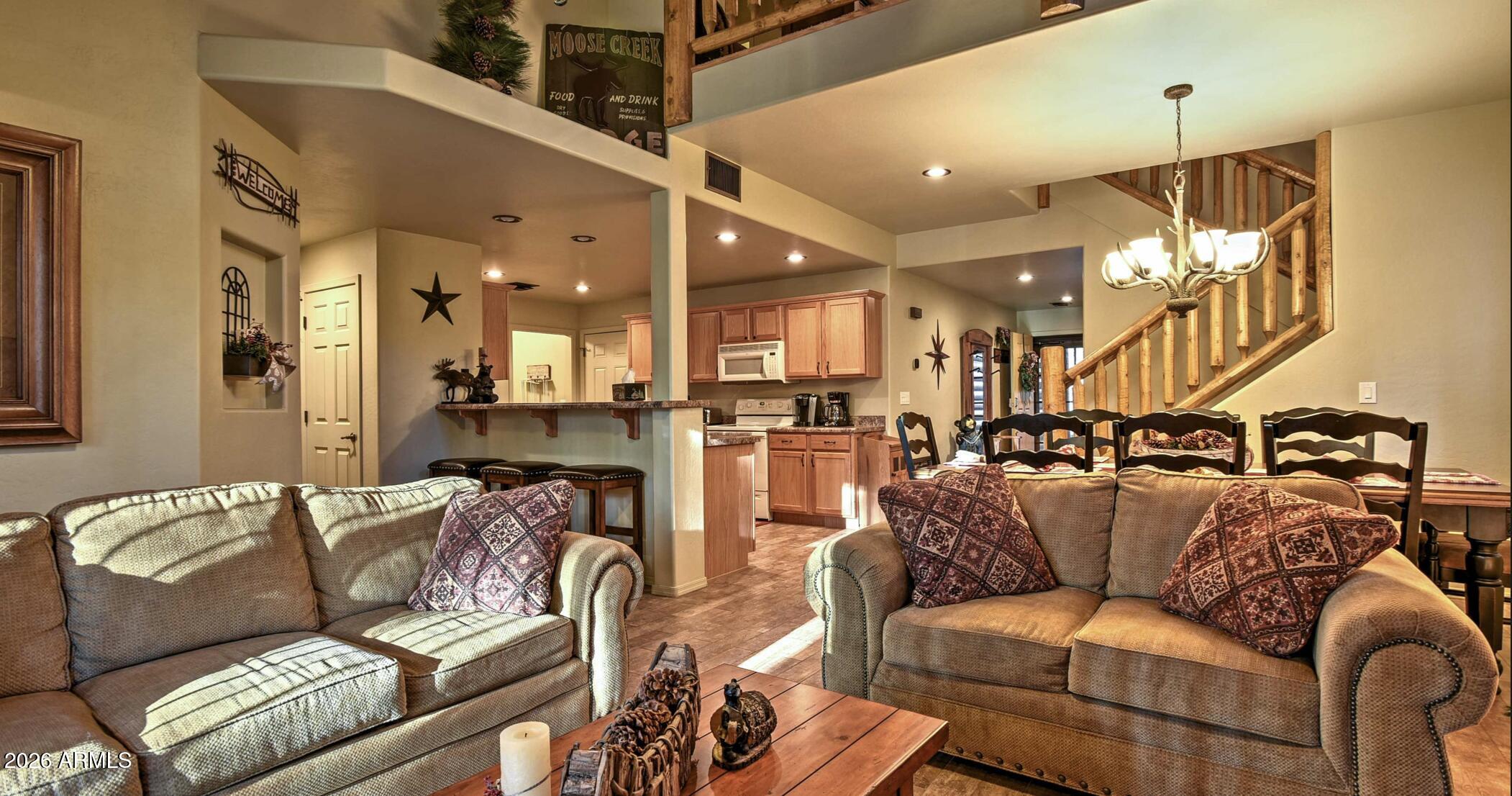 2942 Timber Line Road Pinetop, AZ 85935 - Photo 5 of 27 a living room with furniture and a chandelier