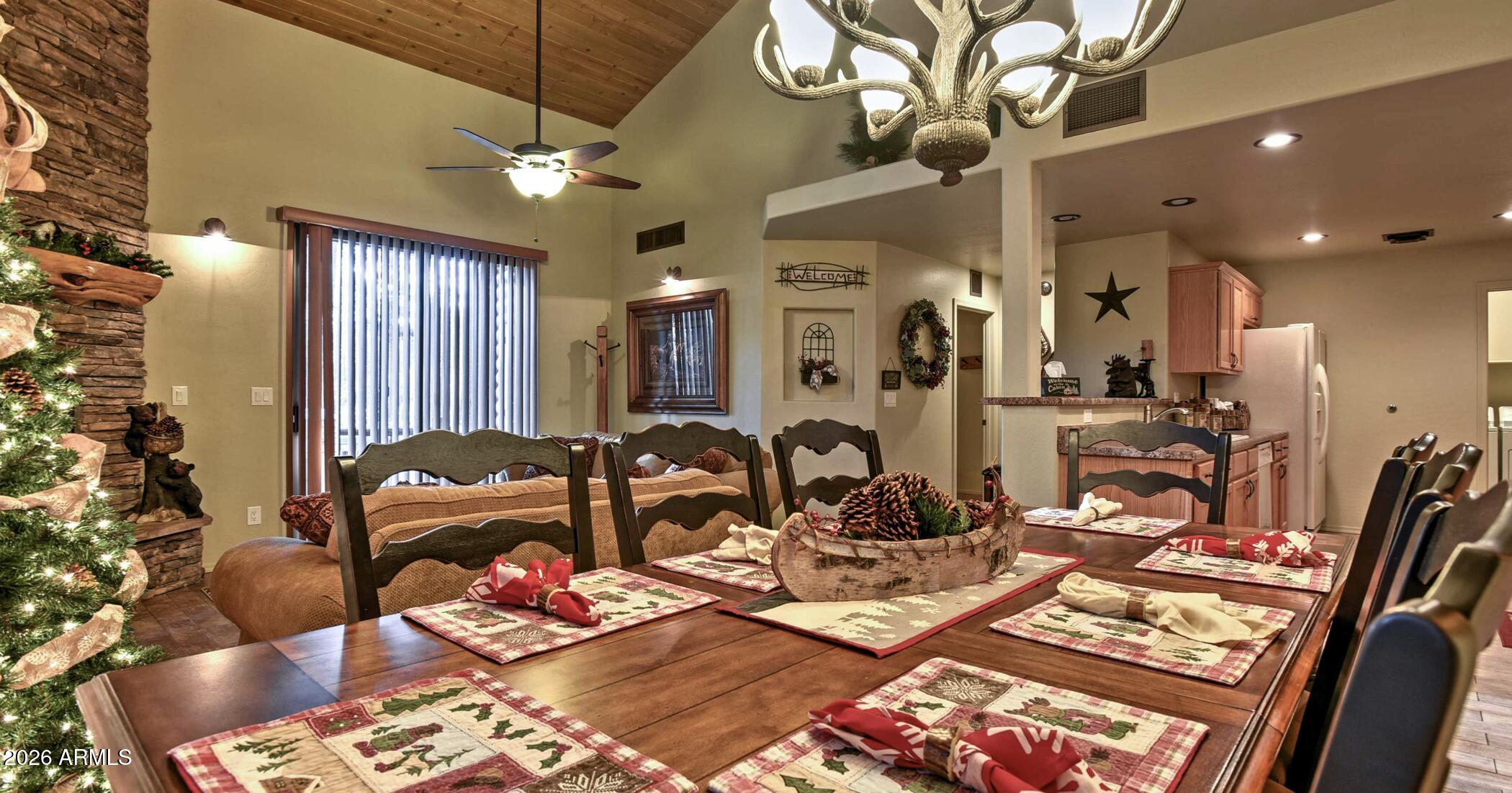 2942 Timber Line Road Pinetop, AZ 85935 - Photo 9 of 27 a living room with lots of furniture and a chandelier