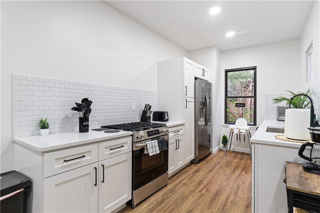 521 Alpine Avenue Pittsburgh, PA 15212 - Photo 11 of 28 a kitchen with a stove cabinets and wooden floor