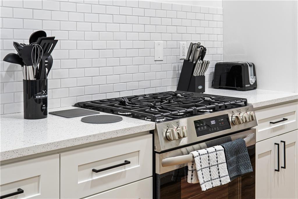 521 Alpine Avenue Pittsburgh, PA 15212 - Photo 15 of 28 a close view of a stove a microwave and cabinets
