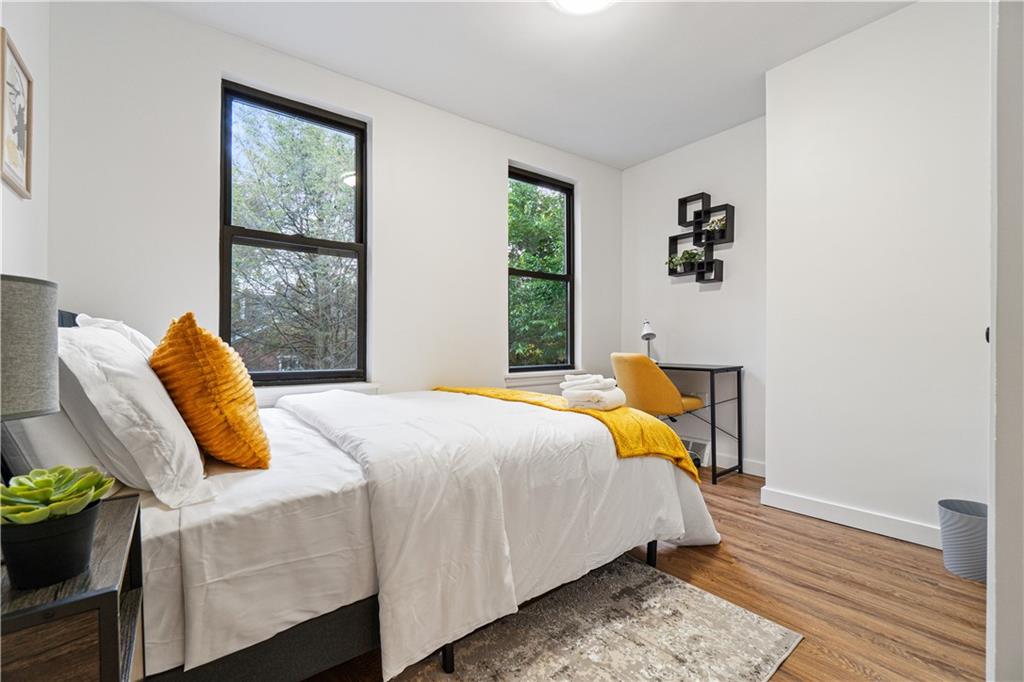 521 Alpine Avenue Pittsburgh, PA 15212 - Photo 23 of 28 a bedroom with a bed and wooden floor