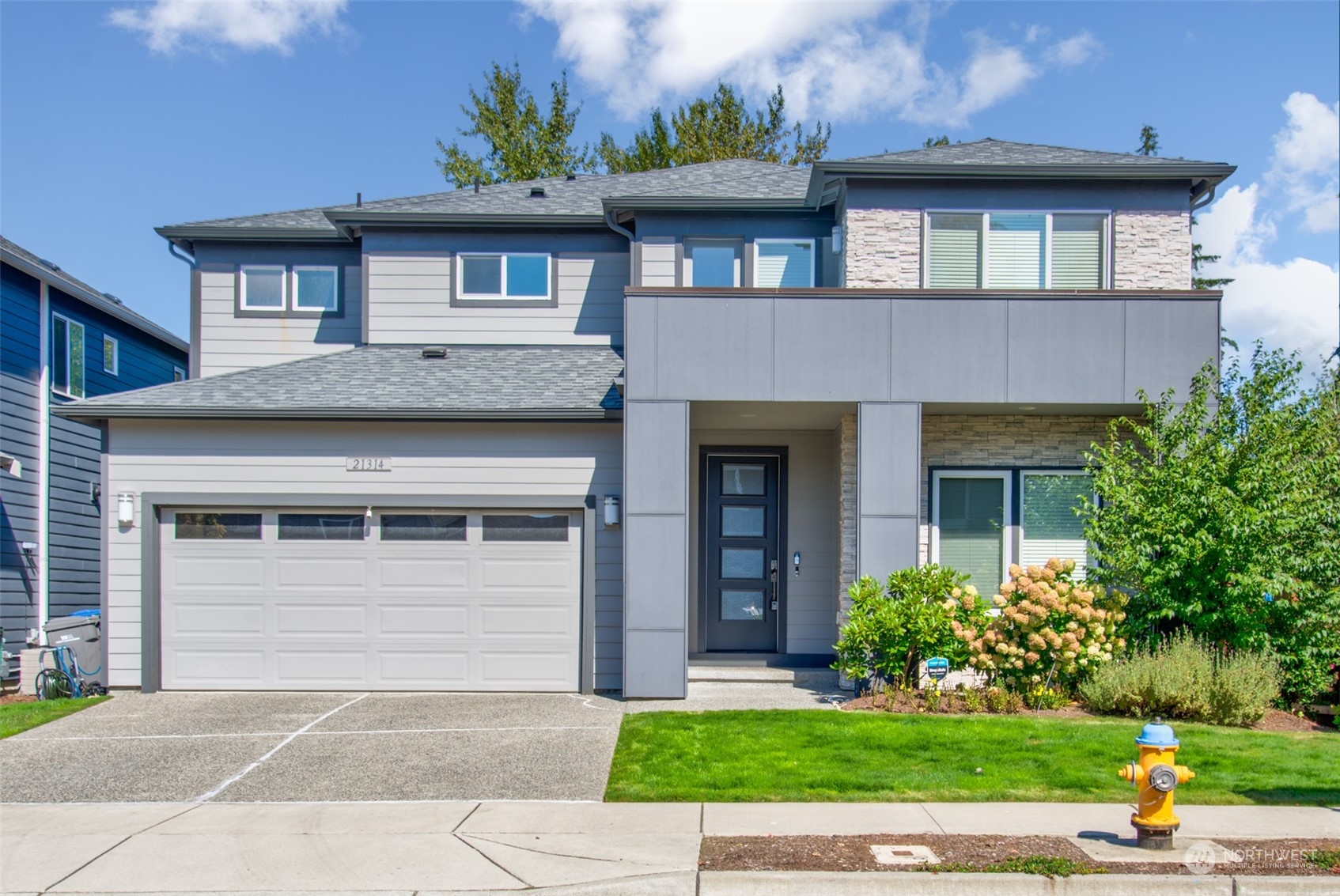 21314 43rd Drive Southeast Bothell, WA 98021 - Photo 1 of 38 a front view of a house with a yard and garage