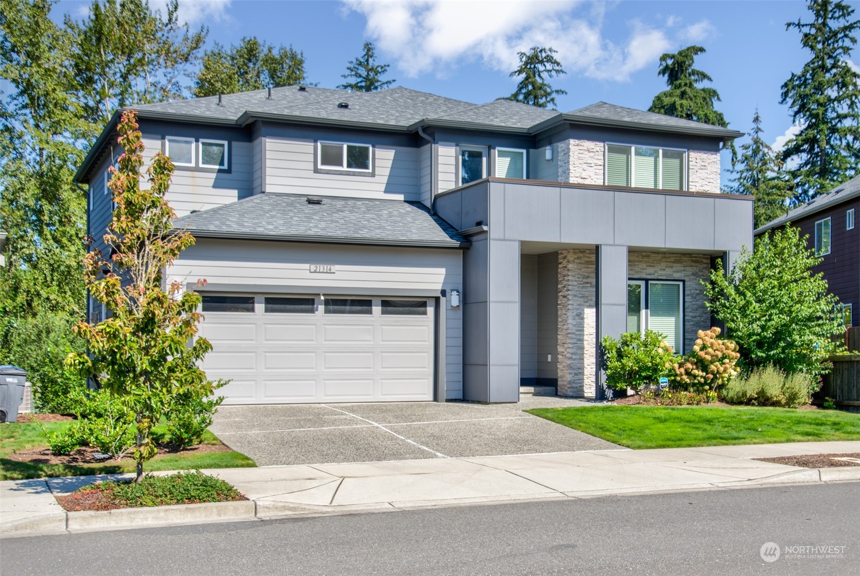 21314 43rd Drive Southeast Bothell, WA 98021 - Photo 2 of 38 a front view of a house with a yard and a garage