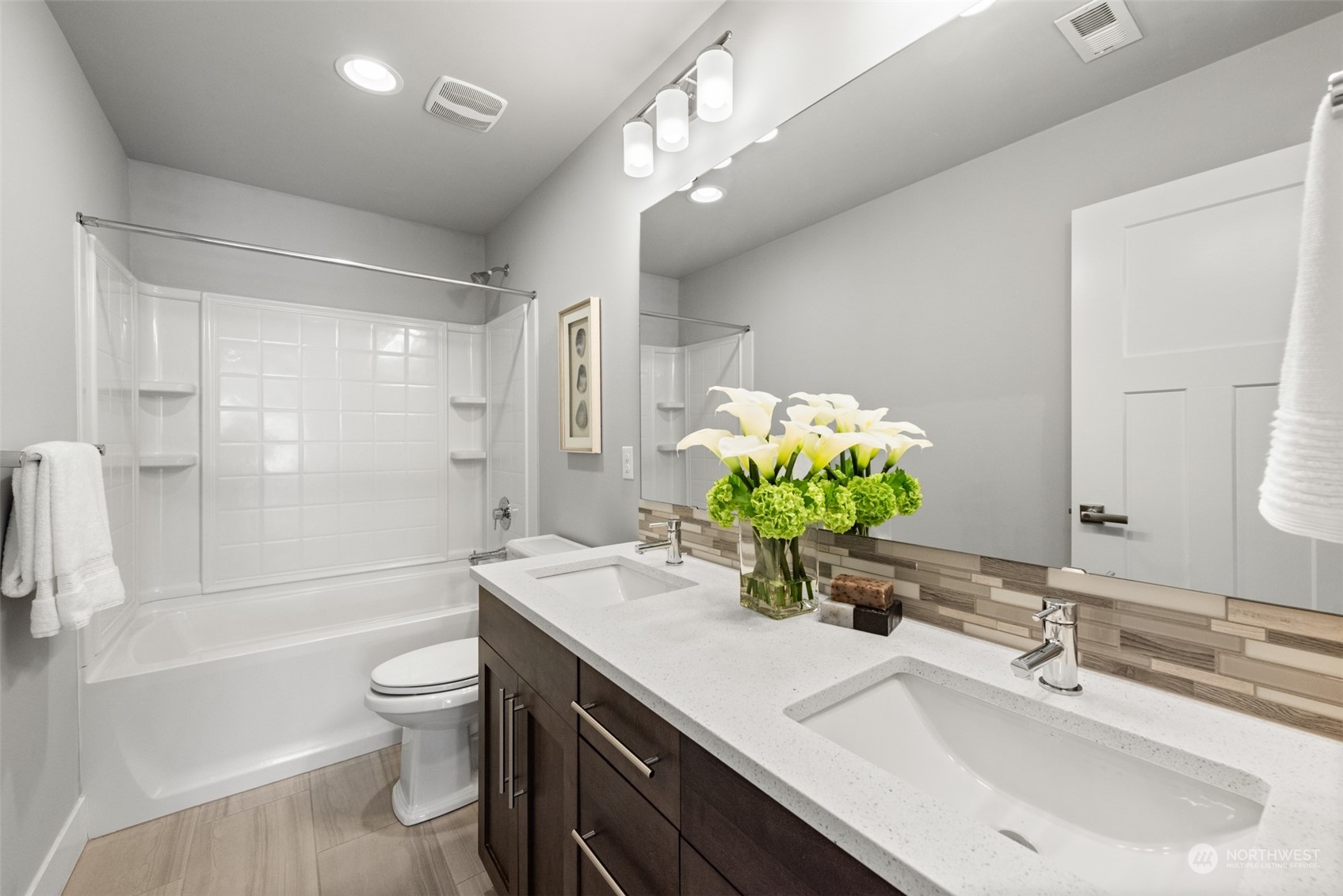 21314 43rd Drive Southeast Bothell, WA 98021 - Photo 28 of 38 a bathroom with a sink a toilet a large mirror a bathtub and shower