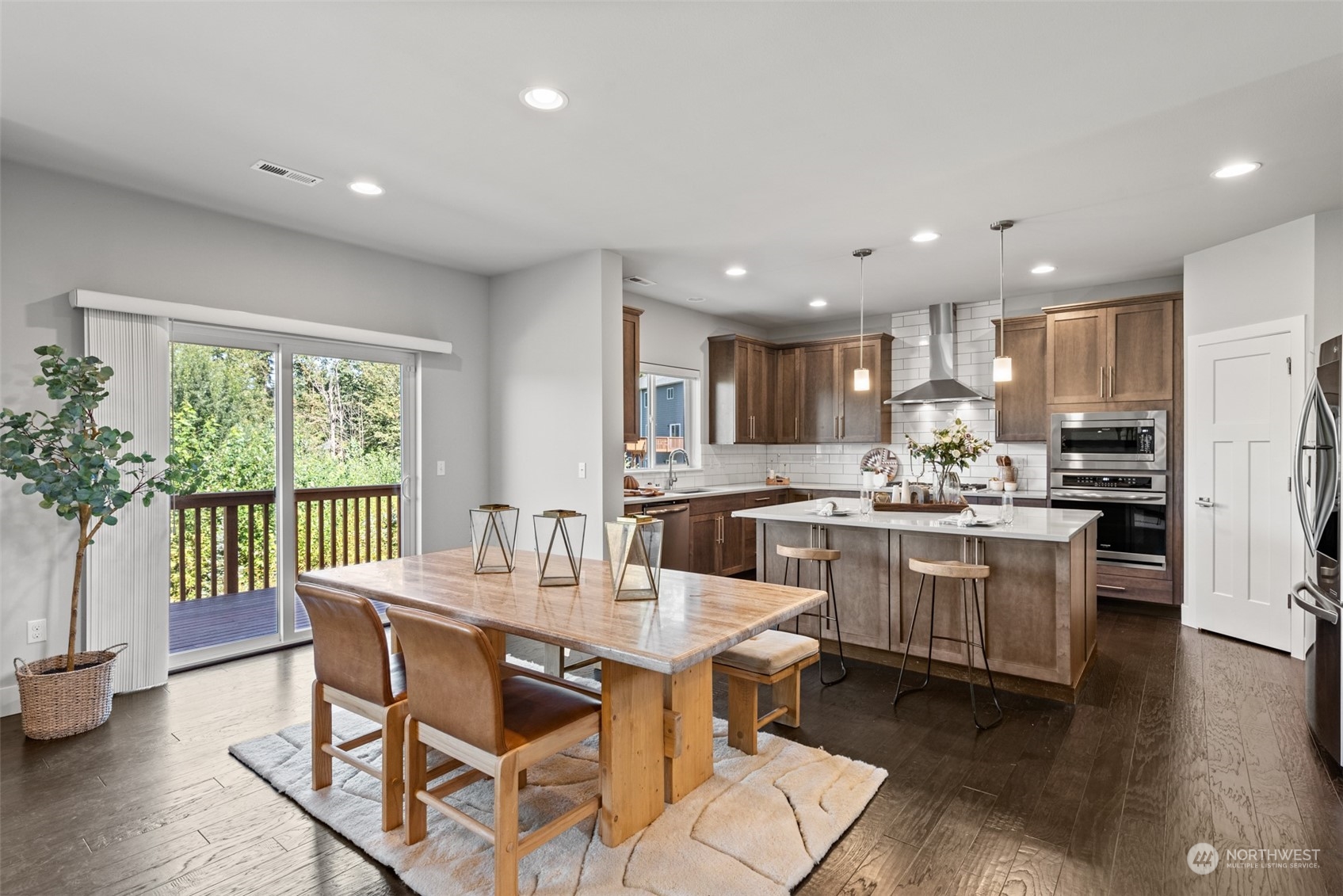 21314 43rd Drive Southeast Bothell, WA 98021 - Photo 8 of 38 a kitchen with kitchen island granite countertop wooden floors and white stainless steel appliances