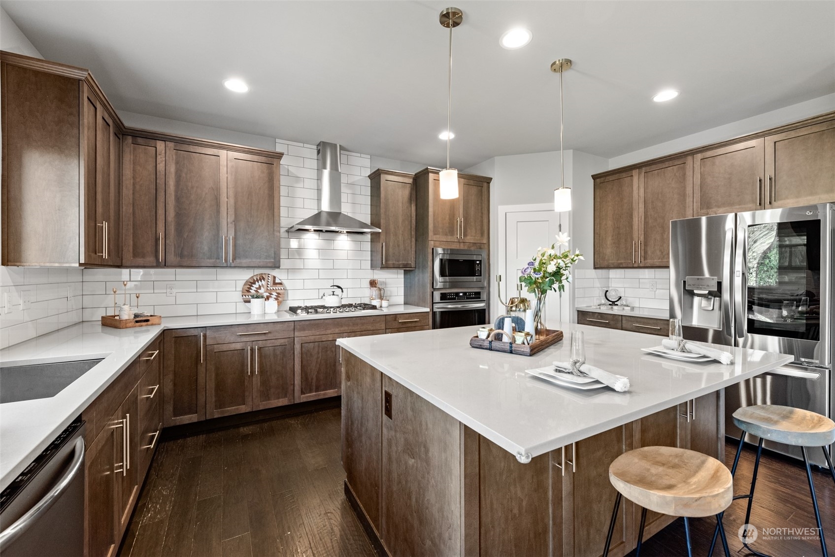 21314 43rd Drive Southeast Bothell, WA 98021 - Photo 10 of 38 a kitchen with a sink a kitchen island and stainless steel appliances