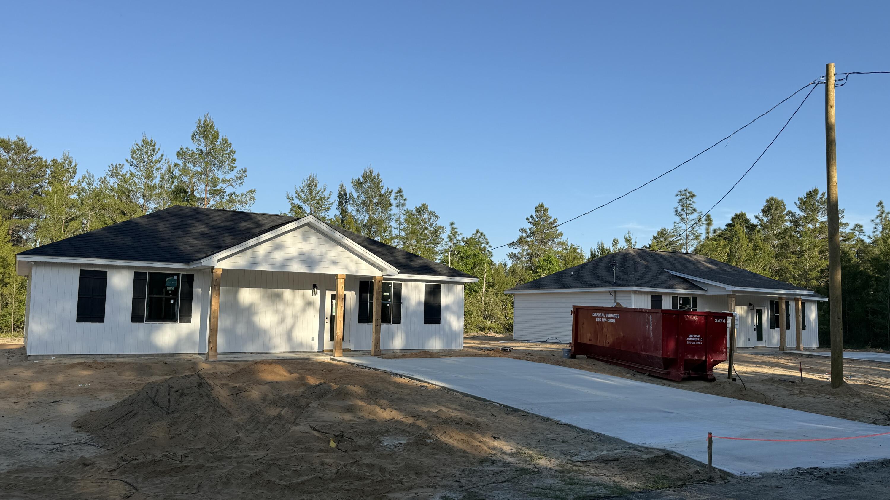 4181 Luar Chipley, FL 32428 - Photo 7 of 28 a front view of a house with a garden and trees