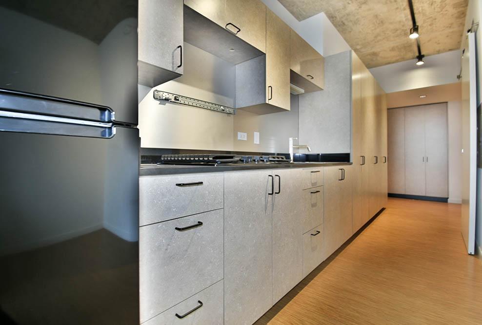 1515 North Fremont Street, Unit 212 Chicago, IL 60642 - Photo 6 of 8 a kitchen with white cabinets and white appliances