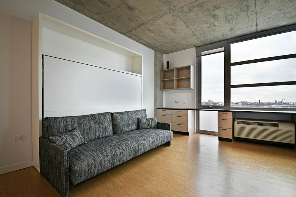 1515 North Fremont Street, Unit 212 Chicago, IL 60642 - Photo 7 of 8 a living room with a couch and a stove top oven