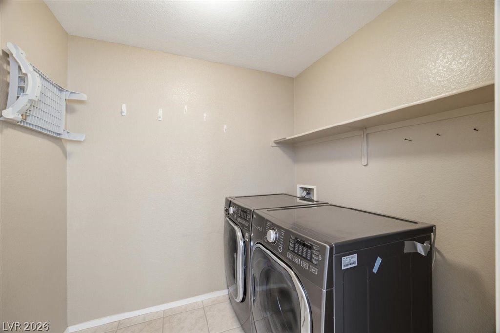 9050 West Warm Springs Road, Unit 1033 Las Vegas, NV 89148 - Photo 15 of 26 Functional laundry room equipped with contemporary appliances and practical shelving.
