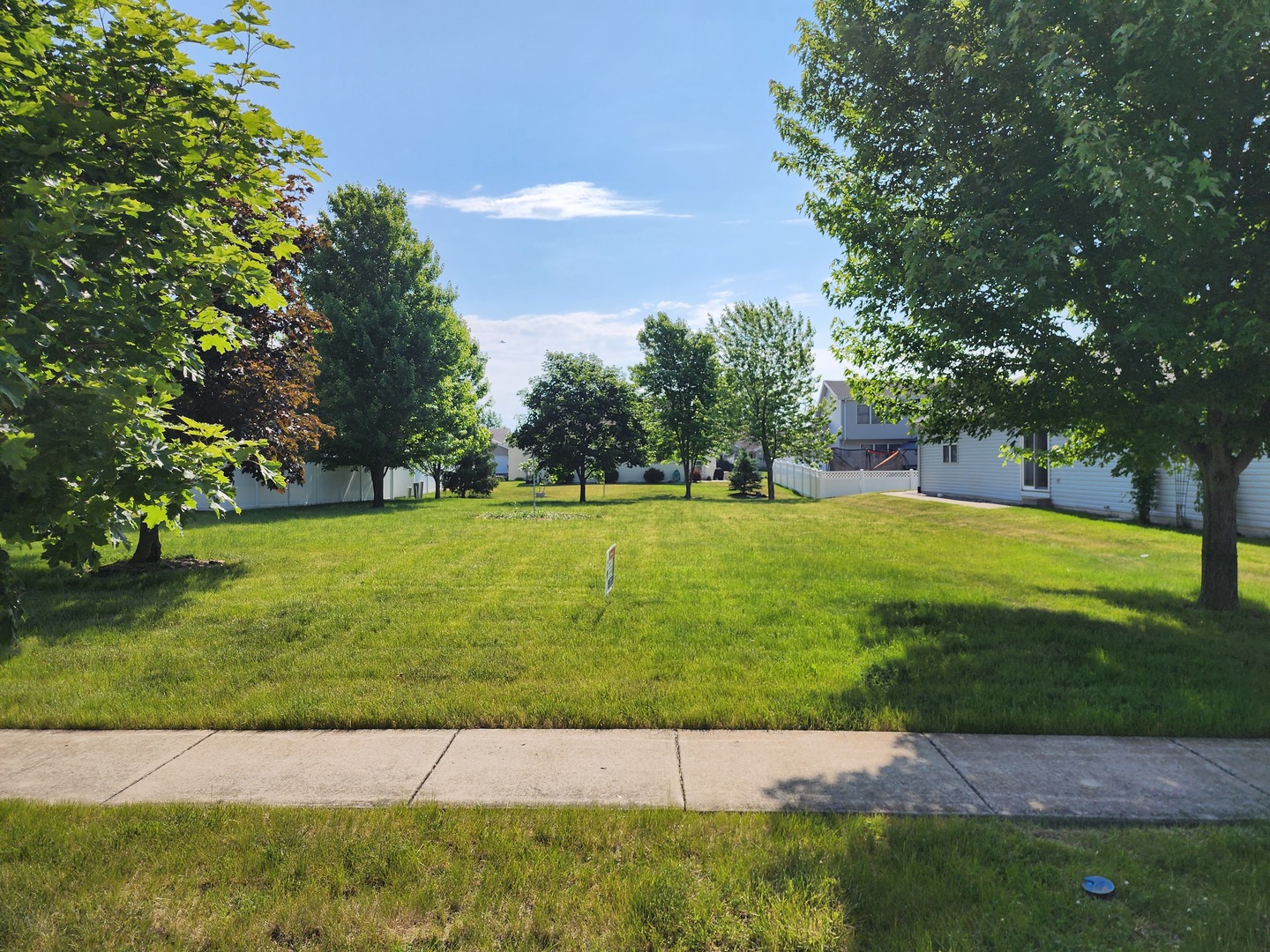 a view of grassy field with grass and trees