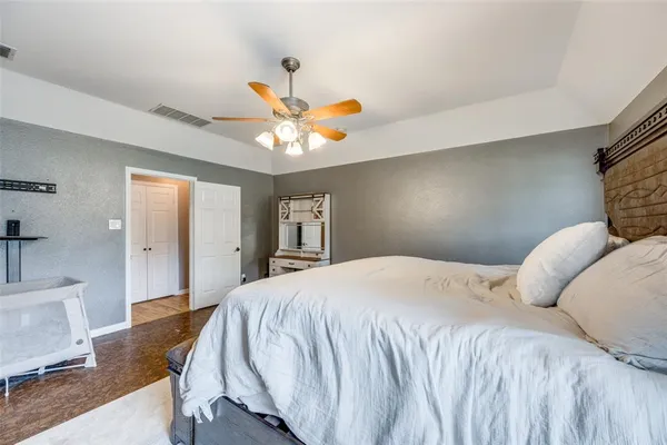 a bedroom with a bed and a chandelier