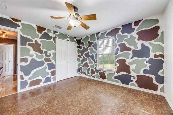 a view of a livingroom with wooden floor and a window