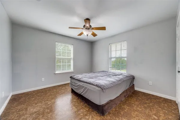 a spacious bedroom with a bed and a window