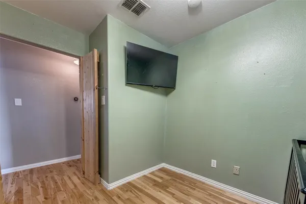a view of a room with wooden floor
