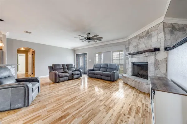 a living room with furniture fireplace and a table