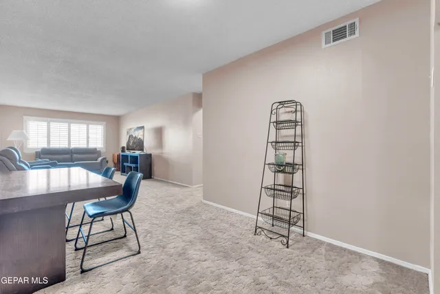 a living room with furniture a window and a flat screen tv