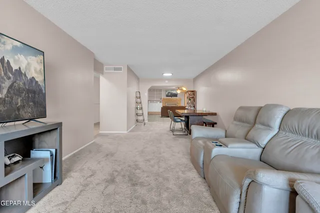 a kitchen with stainless steel appliances granite countertop a refrigerator a stove and a sink