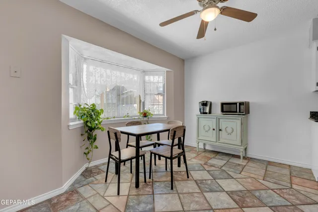 a bathroom with a granite countertop bathtub sink vanity and mirror