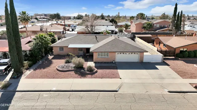 an aerial view of residential houses with city view