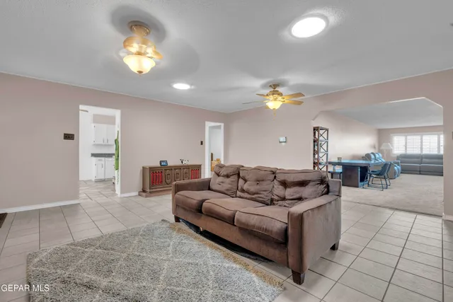 a view of a livingroom with furniture and staircase