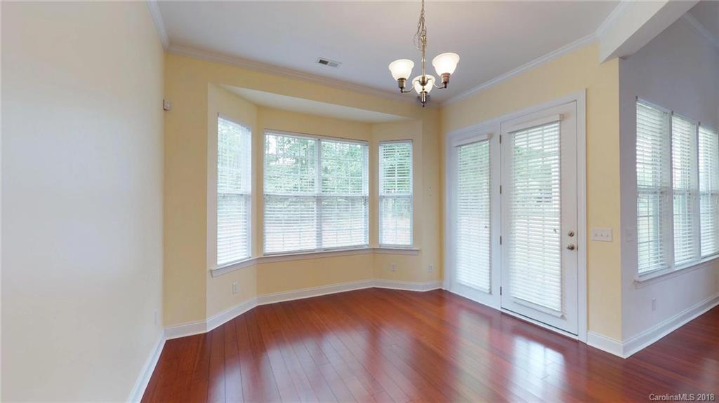1369 Secret Path Drive Fort Mill, SC 29708 - Photo 11 of 22 a view of an empty room with wooden floor and a window