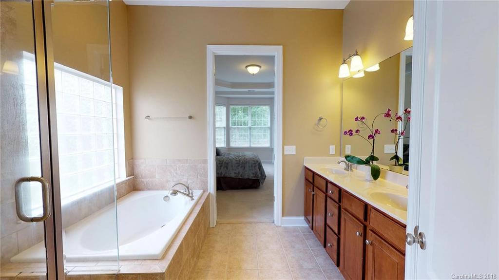 1369 Secret Path Drive Fort Mill, SC 29708 - Photo 14 of 22 a bathroom with a tub sink and mirror