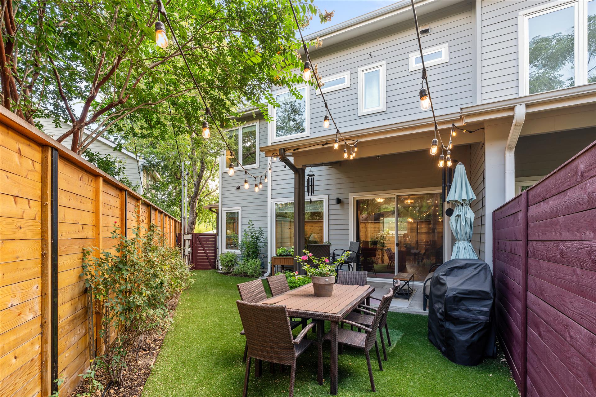 The backyard features low-maintenance artificial turf, providing lush green space without the upkeep, and the fully fenced yard for kids and your four-legged family members.