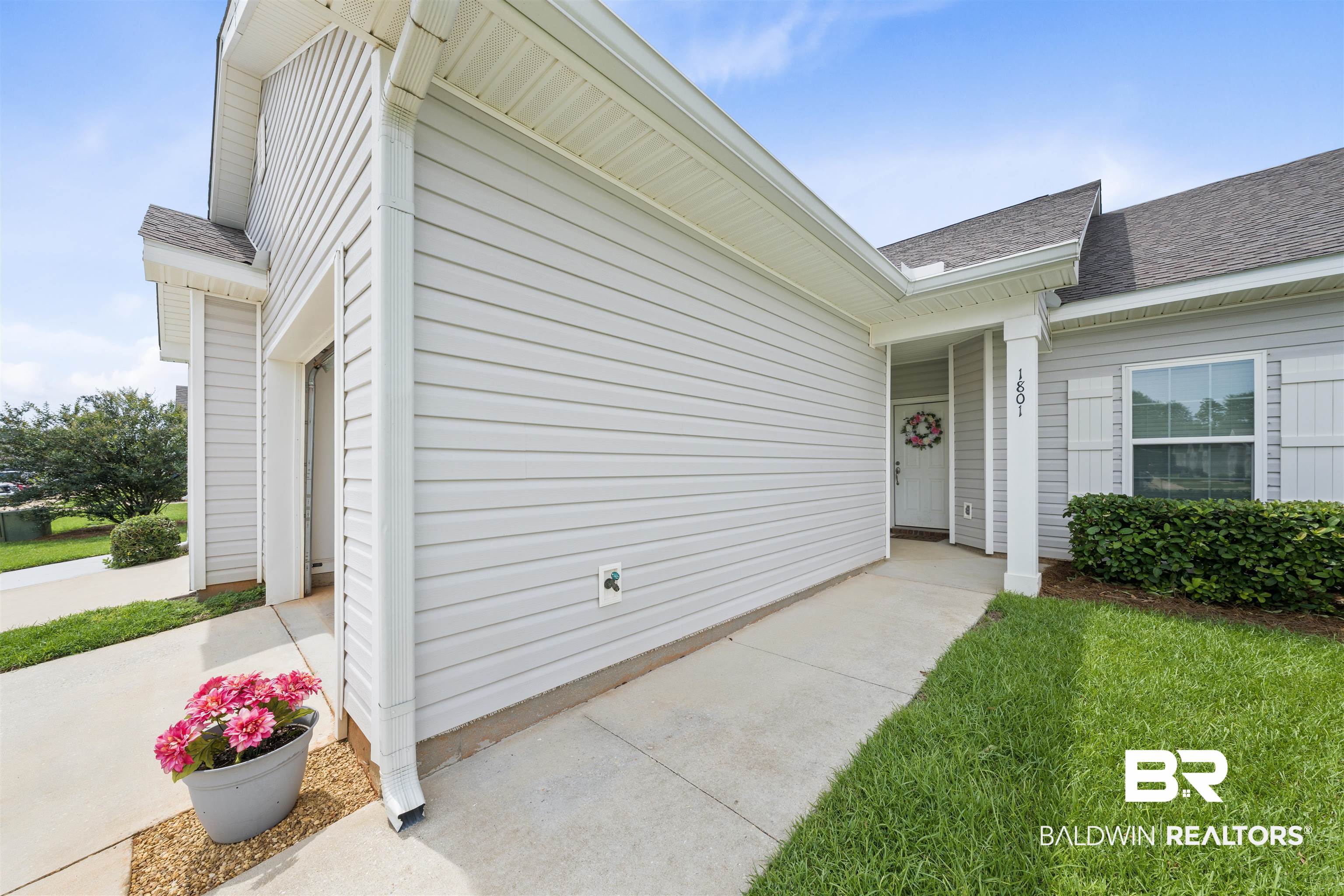 2651 South Juniper Street, Unit 1801 Foley, AL 36535 - Photo 1 of 16 Light gray siding exterior with white trim and a covered entryway