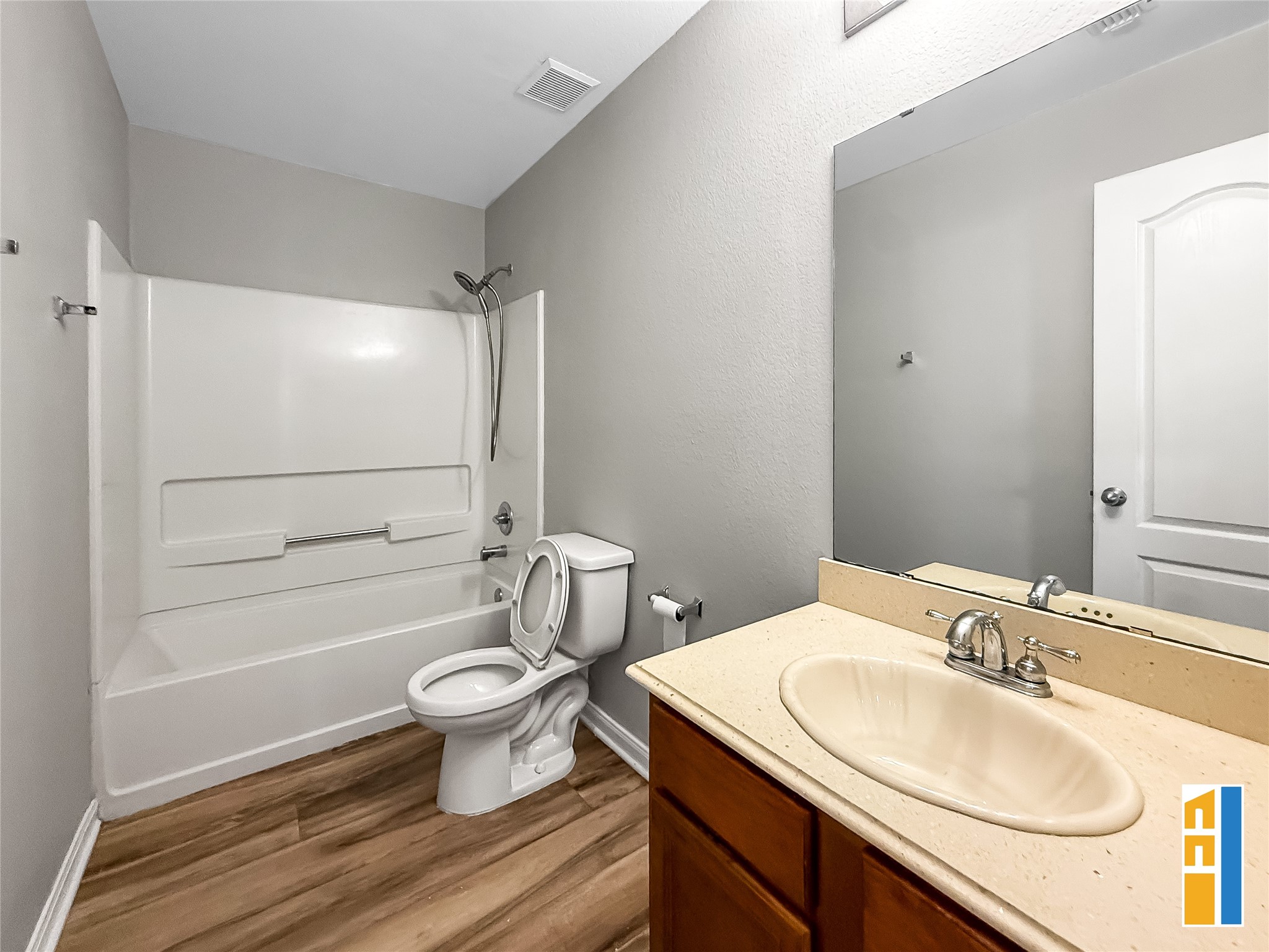 29566 North Legends Bend Drive Spring, TX 77386 - Photo 20 of 21 This inviting secondary bathroom features sleek wood-look flooring, a spacious vanity, and a modern shower-tub combo, offering both style and functionality.