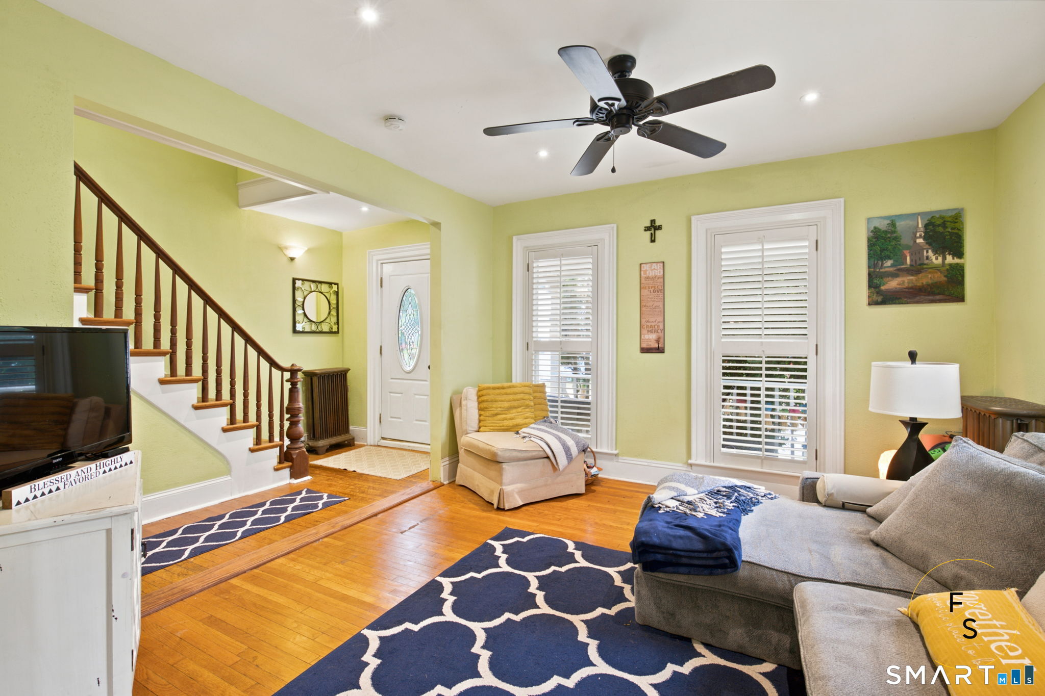 182 Broad Street Norwich, CT 06360 - Photo 7 of 30 a living room with furniture ceiling fan and a rug