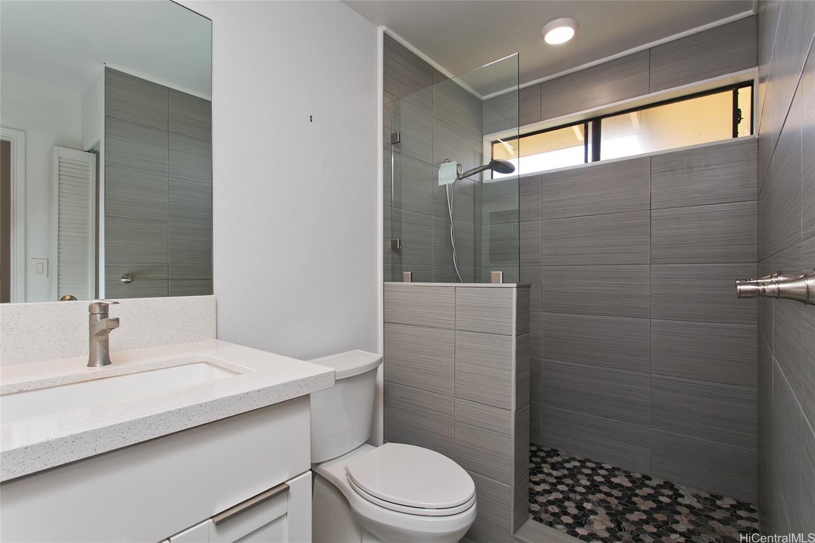 600 Kahiau Loop Honolulu, HI 96821 - Photo 14 of 19 a bathroom with a sink a toilet and shower