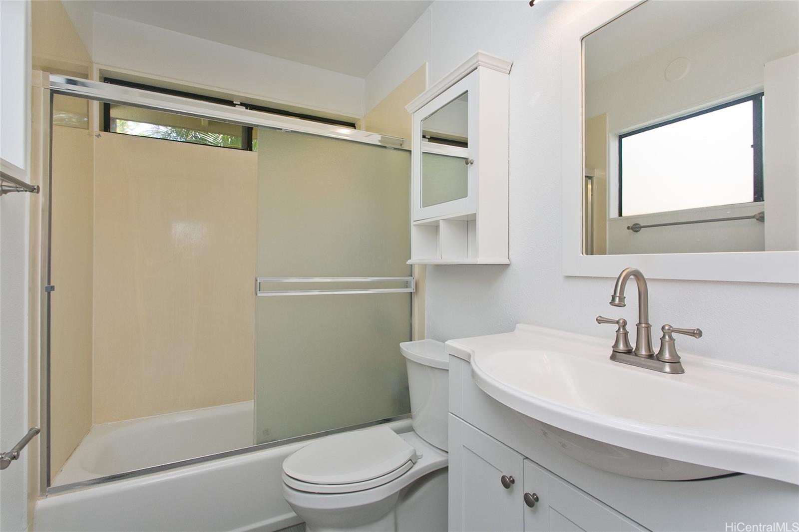 600 Kahiau Loop Honolulu, HI 96821 - Photo 16 of 19 a bathroom with a sink mirror vanity and toilet