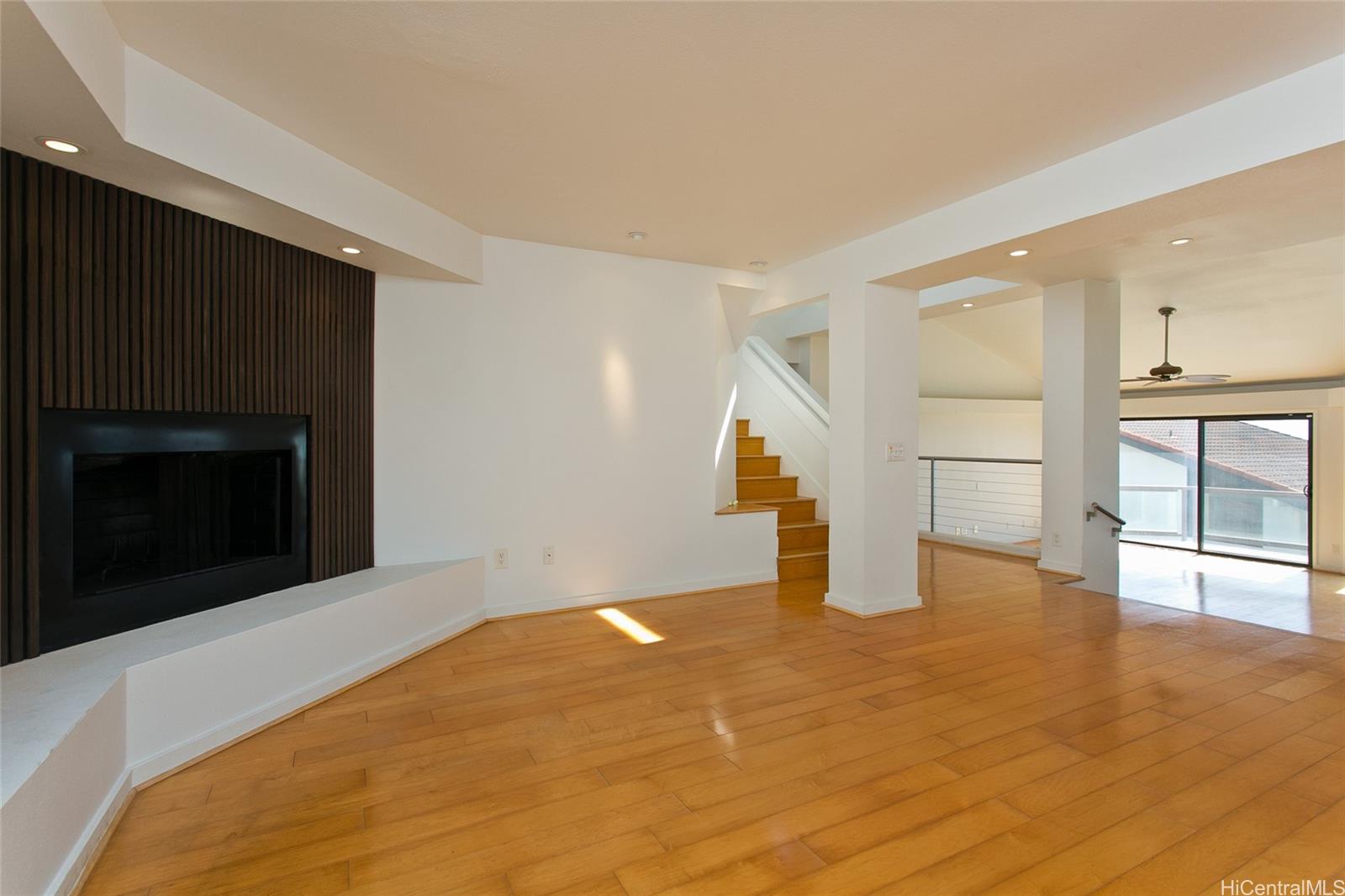 600 Kahiau Loop Honolulu, HI 96821 - Photo 10 of 19 a view of empty room with wooden floor and fireplace