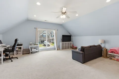 a view of a house with a yard and sitting area